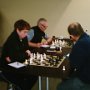 James Watson unleashes a home brew variation against Russell Murray's Caro Kann. Ben Kersten contemplates his move in the background.